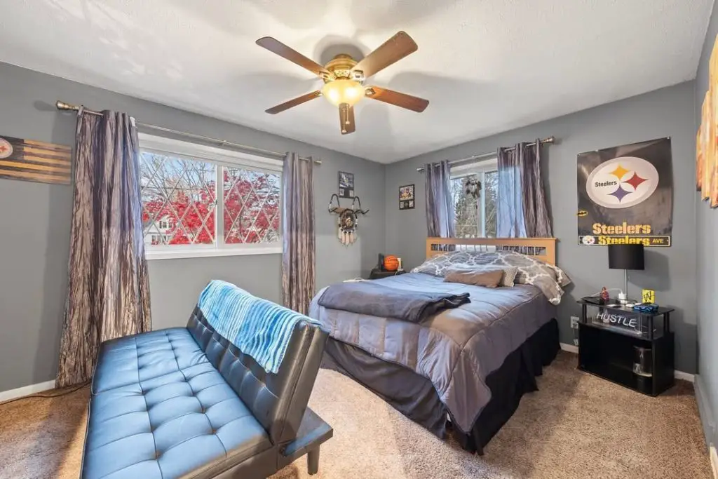Twin bedroom with basketball theme grey beds and gallery wall display