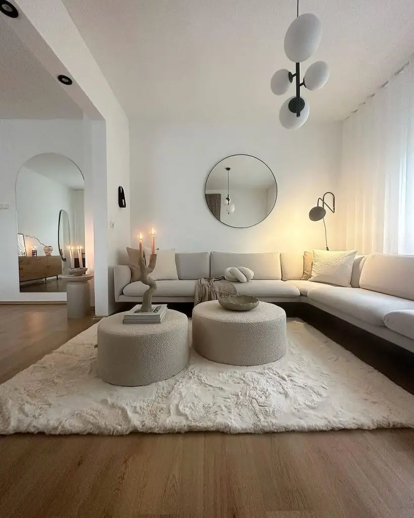 White minimalist living room with round mirrors and textured furniture