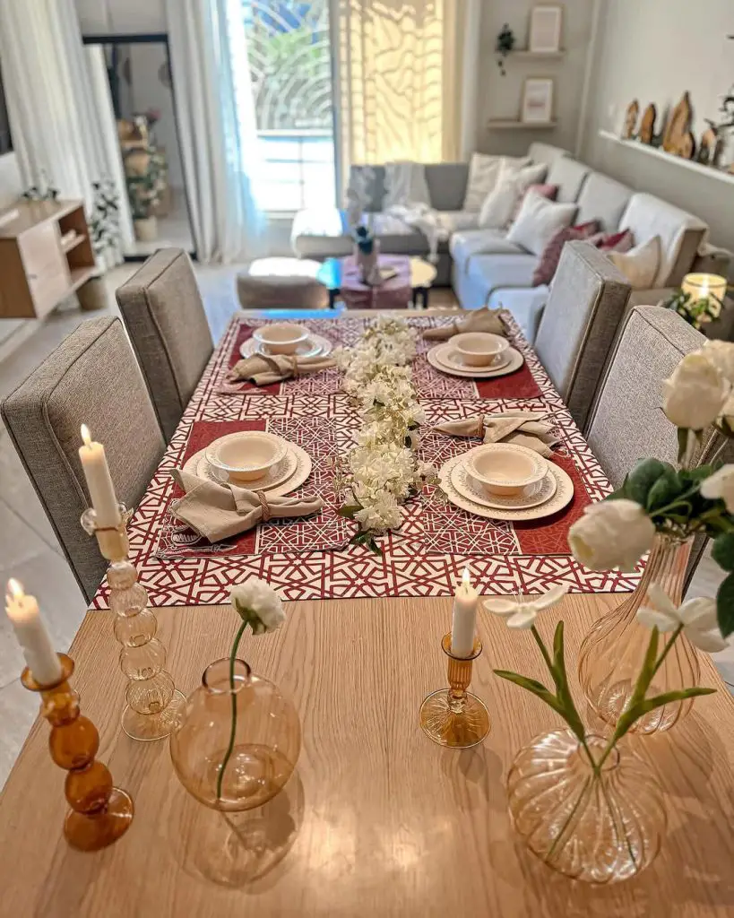 Modern dining table with red geometric runner and amber glassware