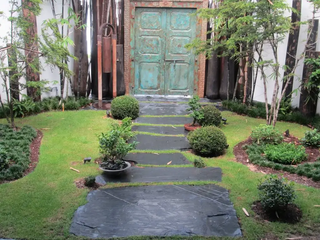 Modern concrete pathway with geometric pattern and architectural plants