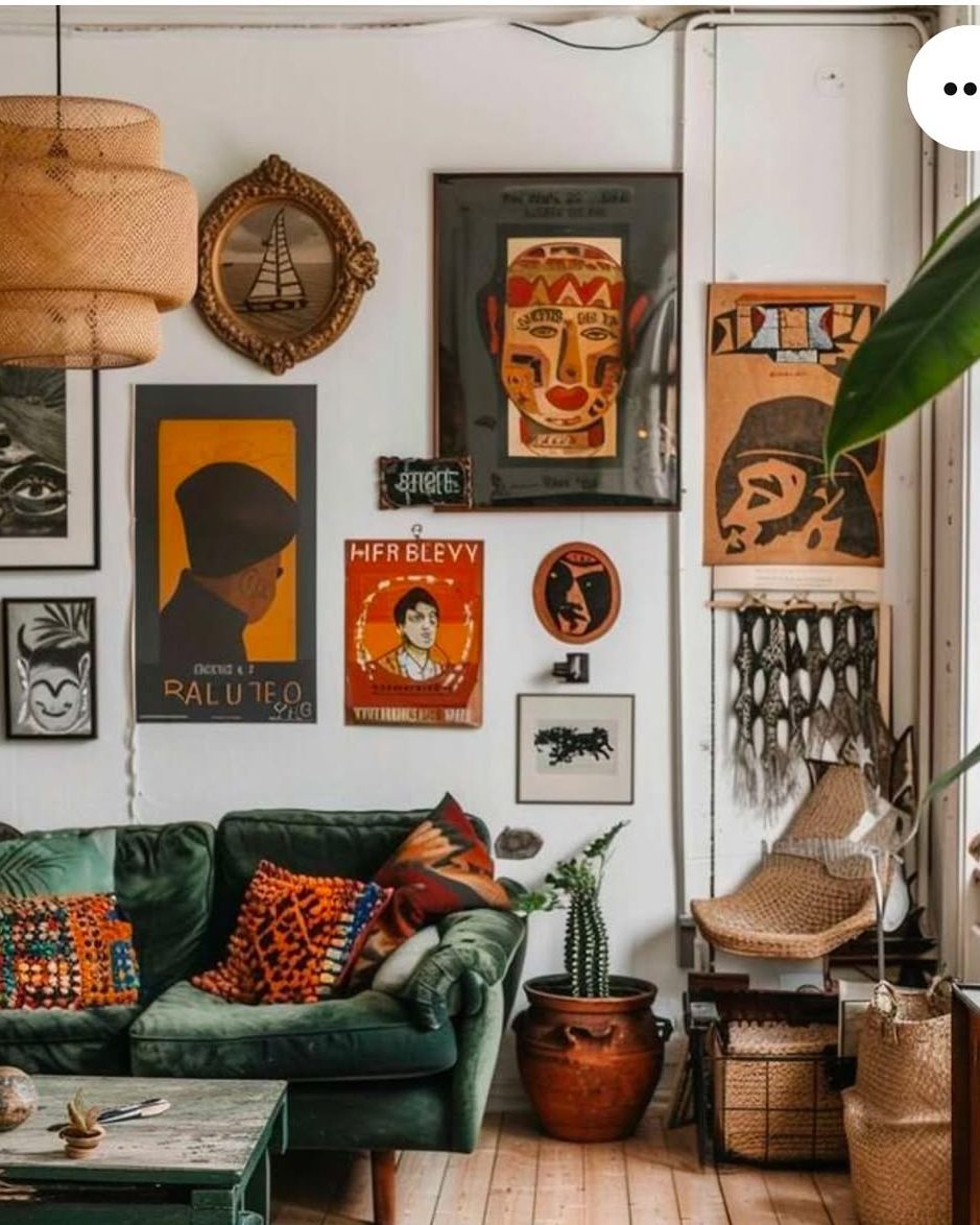 Green velvet sofa with vintage poster gallery and woven decor