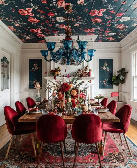 Dining room with floral ceiling blue chandelier and red velvet chairs