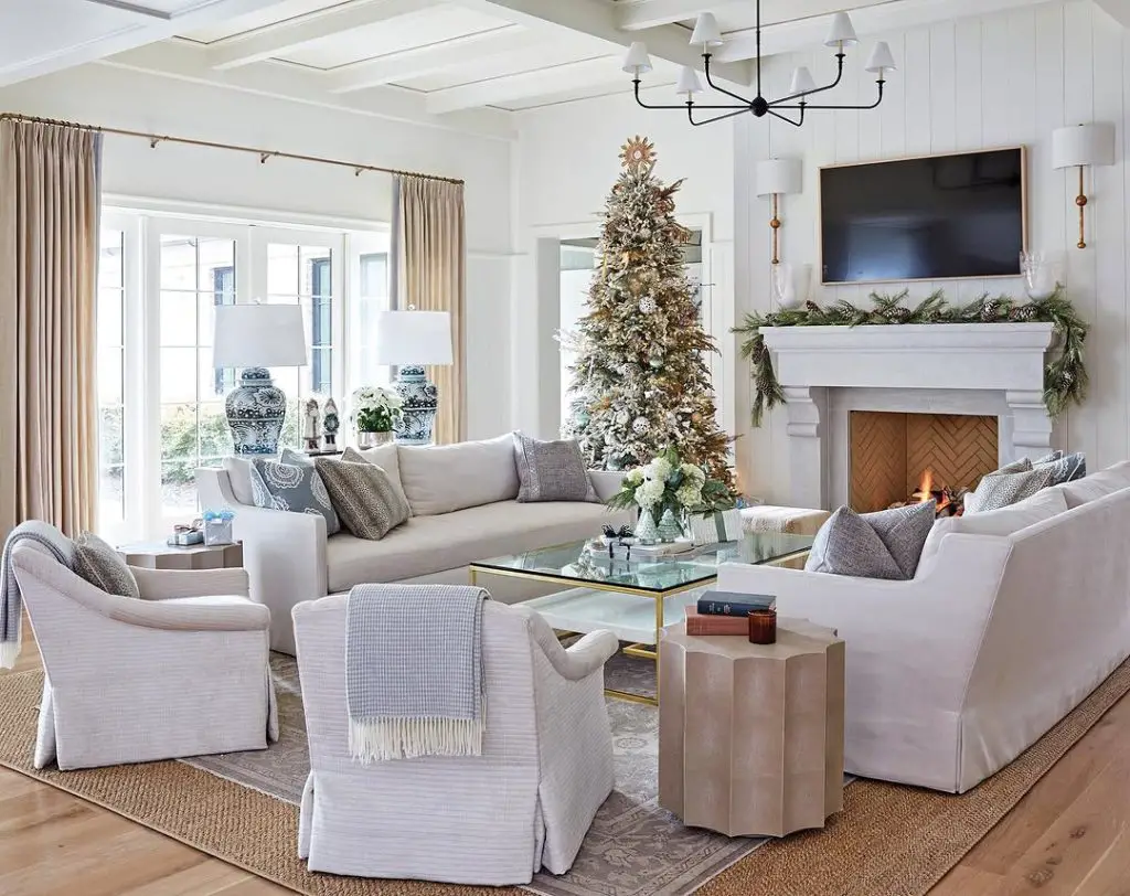 White living room with Christmas tree and modern furniture pieces