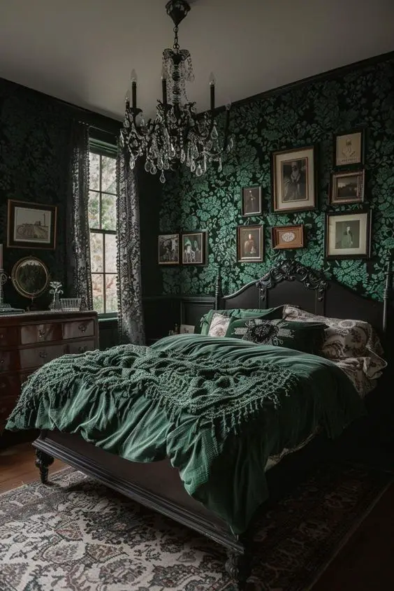 Victorian bedroom with green damask wallpaper and vintage portraits
