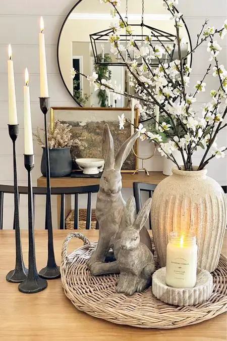 Modern spring display with rabbits candles and cherry blossoms