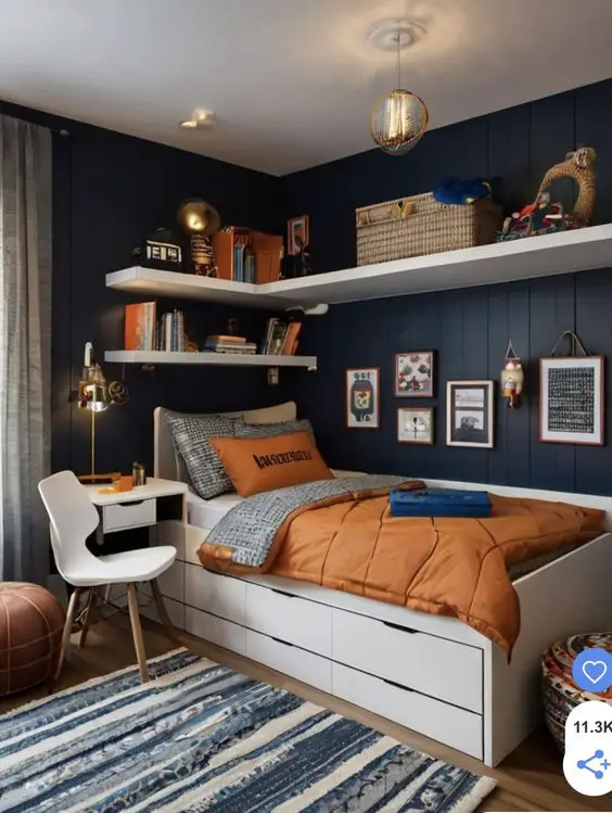 Navy blue bedroom with white storage bed and copper accents