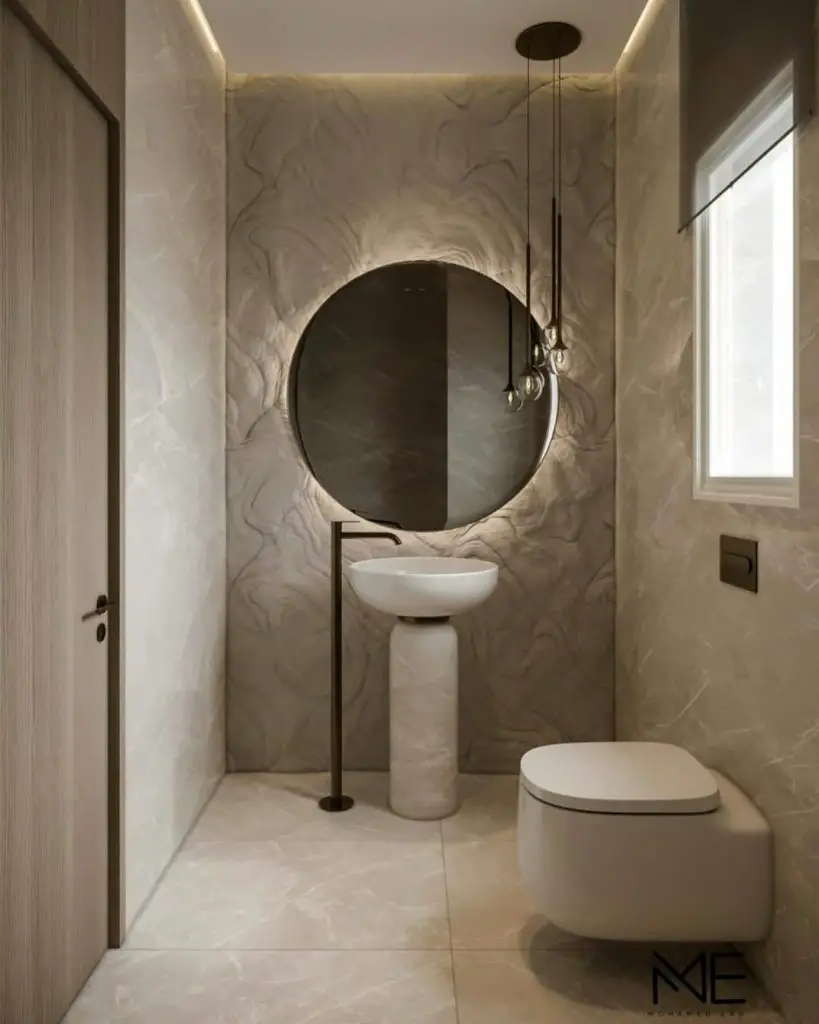 Elegant powder room with textured marble walls pedestal sink and round mirror