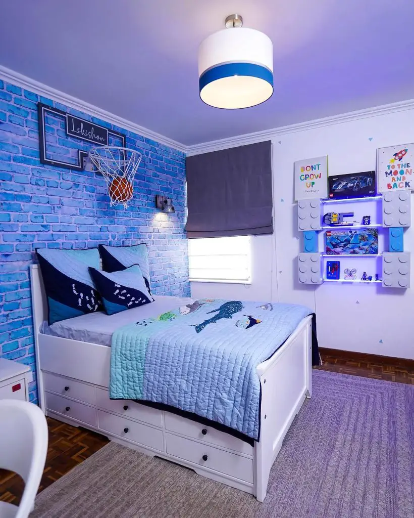 Boys bedroom with blue brick wall basketball hoop and Lego display shelves