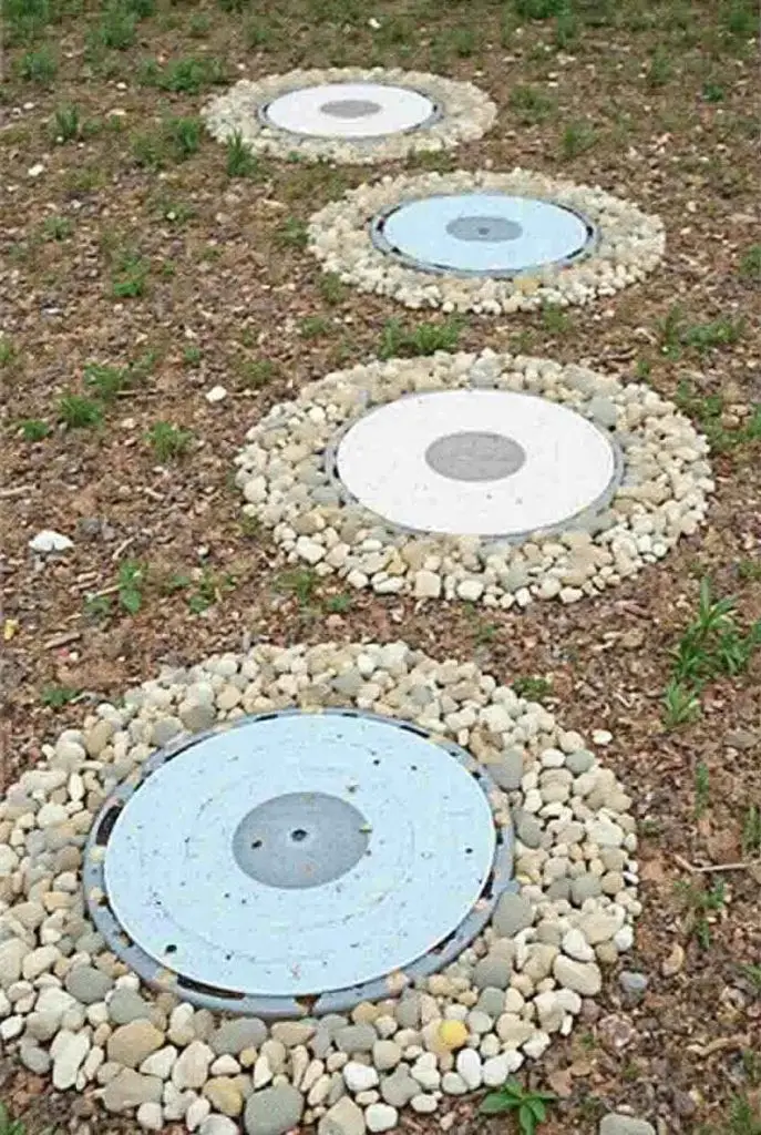 White circular stepping stones bordered by small rocks