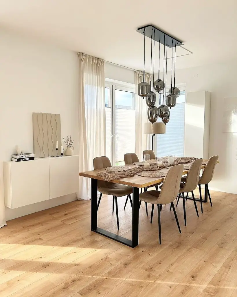Open concept dining space with wooden furniture gallery wall and pendant lighting
