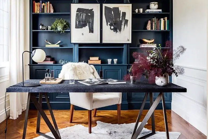 Navy shelving office with black desk and geometric rug