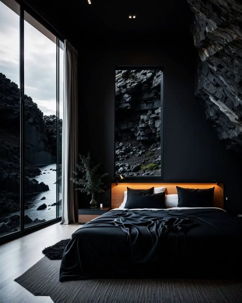 Modern dark bedroom with floor length windows overlooking rocky coastline
