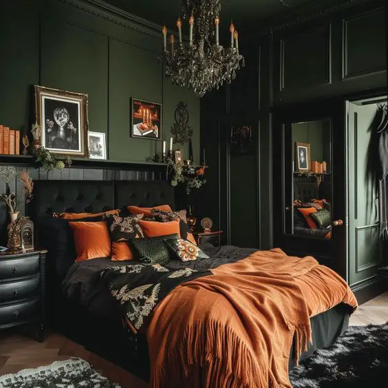 Dark green bedroom with orange bedding and crystal chandelier