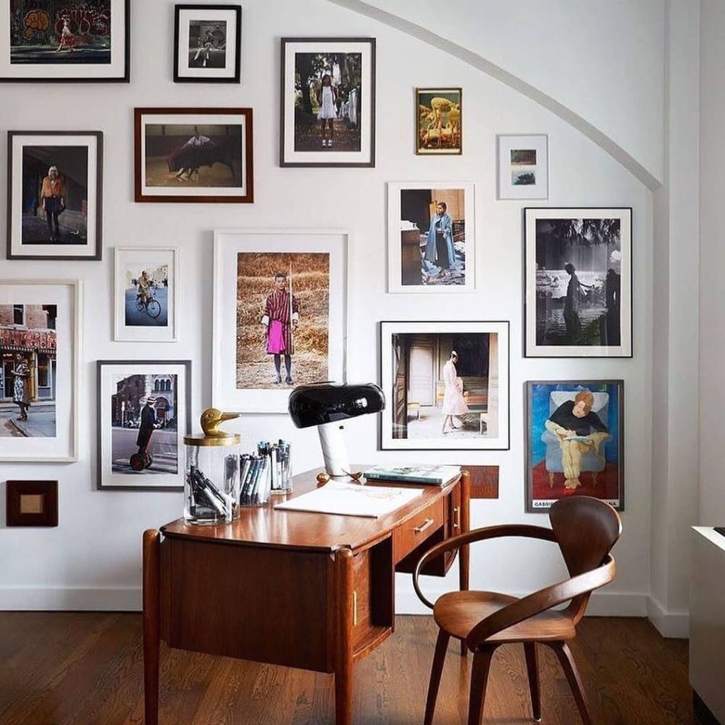 Modern white office space with pegboard walls and multiple workstations
