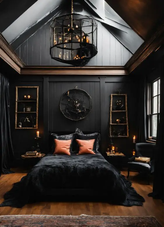 Black bedroom with geometric chandelier and orange accent pillows