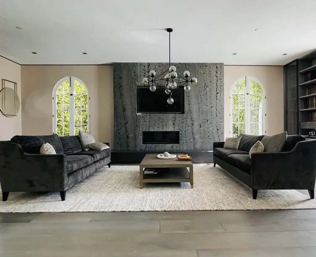 Modern living room with twin arched windows and velvet sofas