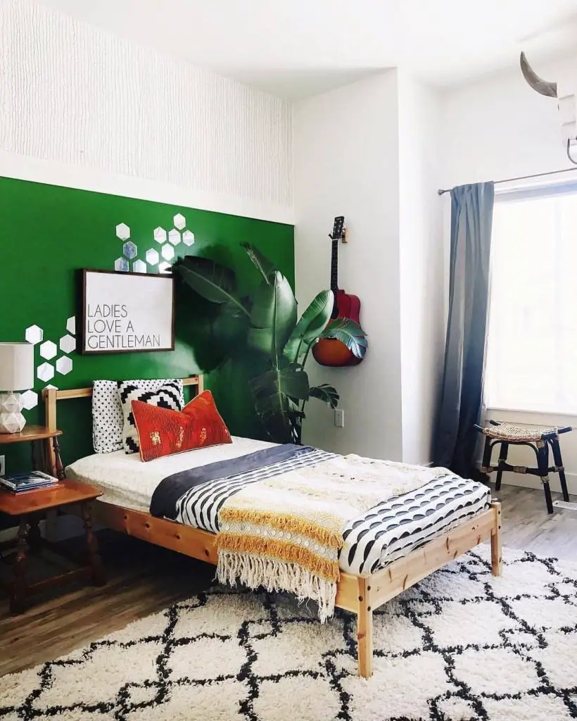 Teen bedroom with green accent wall wooden bed and tropical plant decor