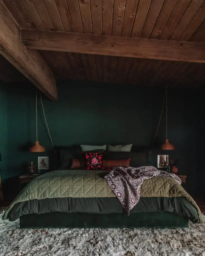 Monochromatic green bedroom with mirrors textured bedding natural accents