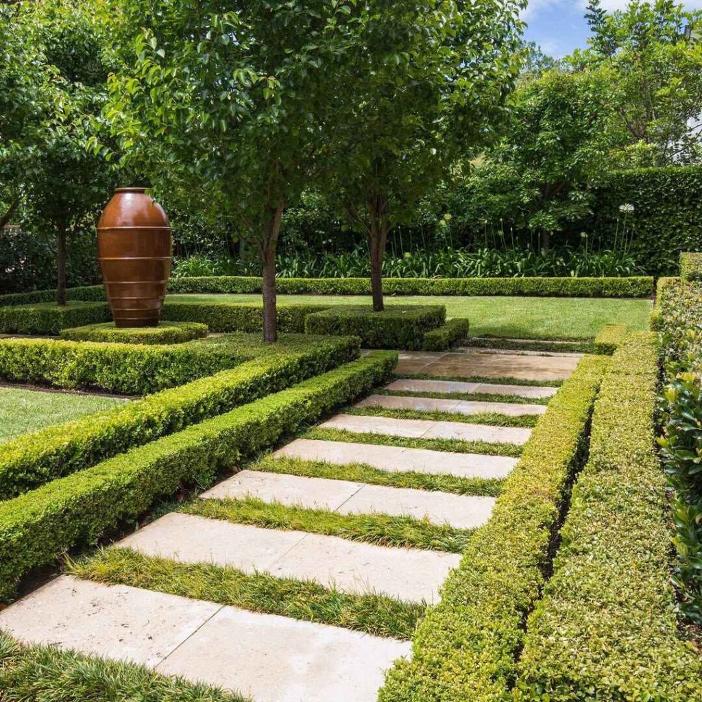 Stone pathway through coastal garden with ornamental grasses