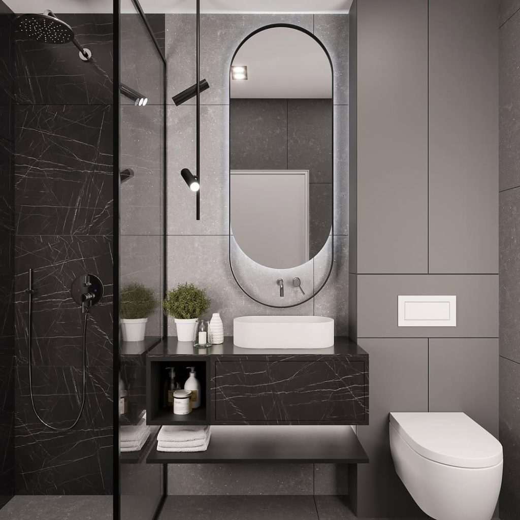 Grey and black modern bathroom with oval mirror and vessel sink