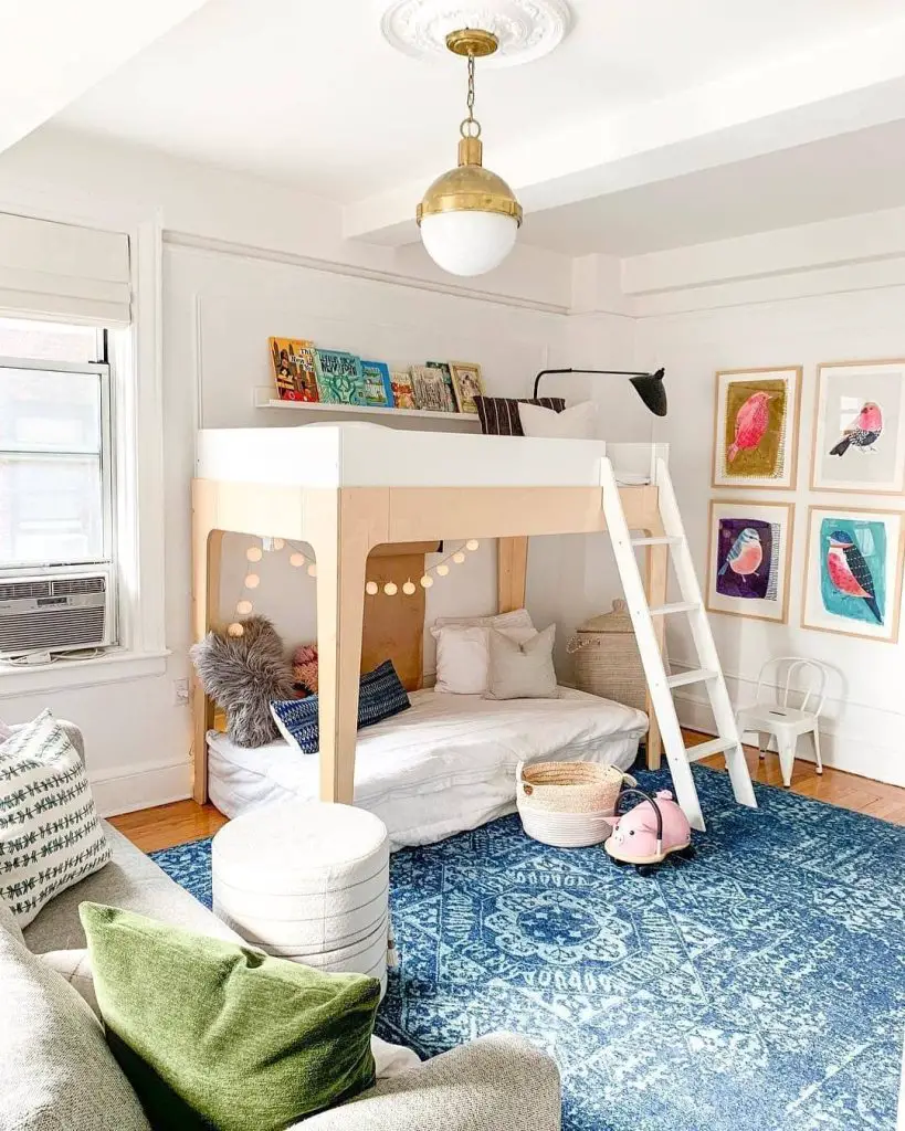 Girls bedroom with loft bed bird artwork and brass pendant light