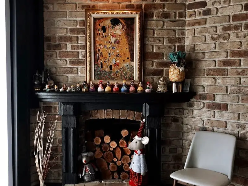 Brick fireplace with Klimt art display