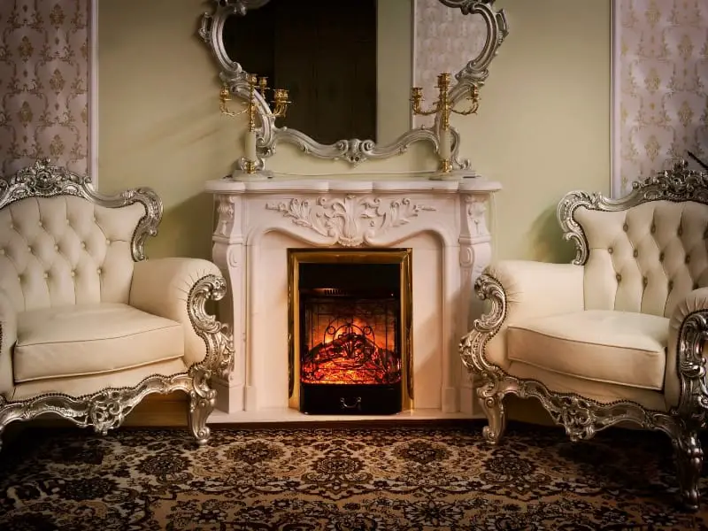 Ornate baroque fireplace with gilded chairs