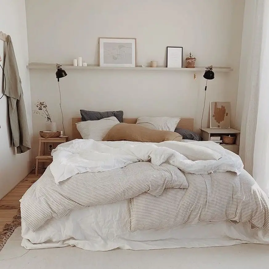 Neutral bedroom with white bedding wooden accents and wall mounted shelf