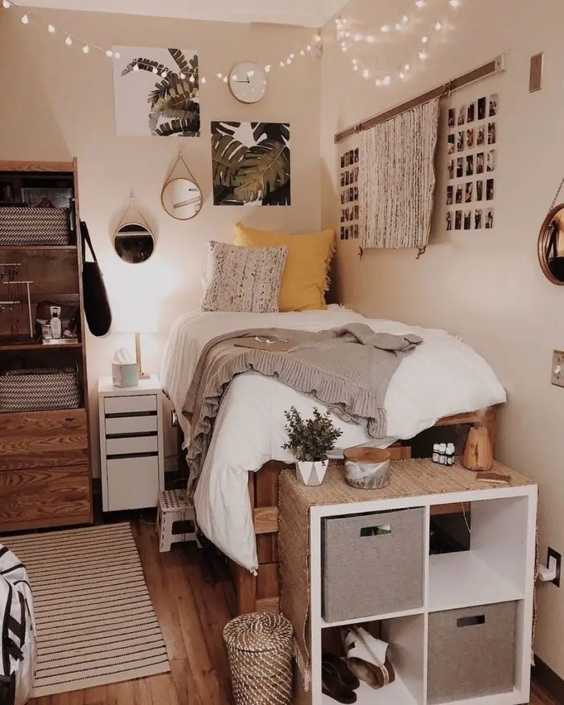 Small bedroom with raised bed storage cubes and botanical wall art