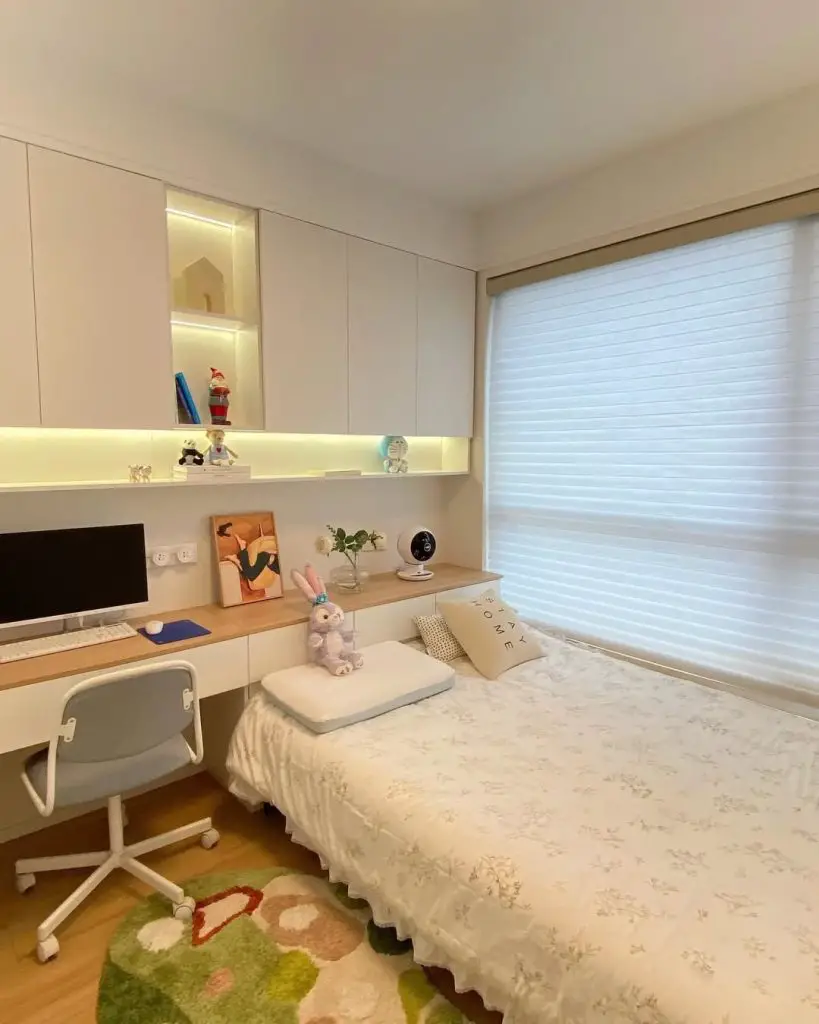 Modern bedroom with built in desk LED shelving and white furniture