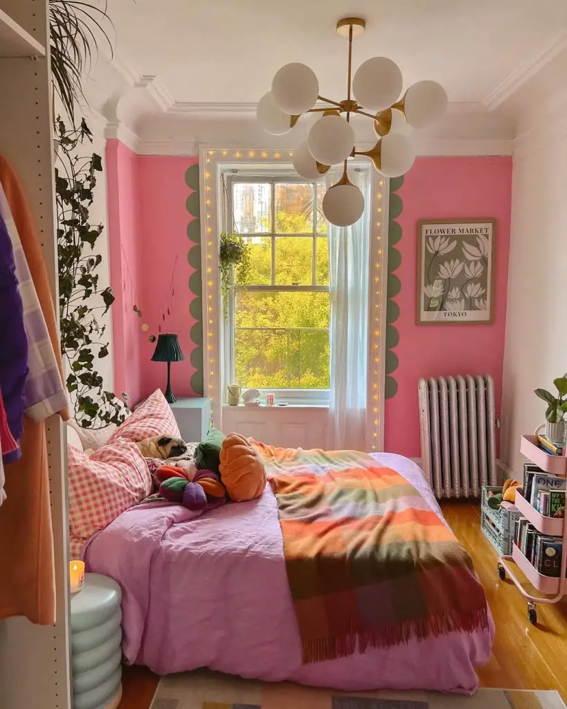 Pink bedroom with globe chandelier string lights and rainbow bedding