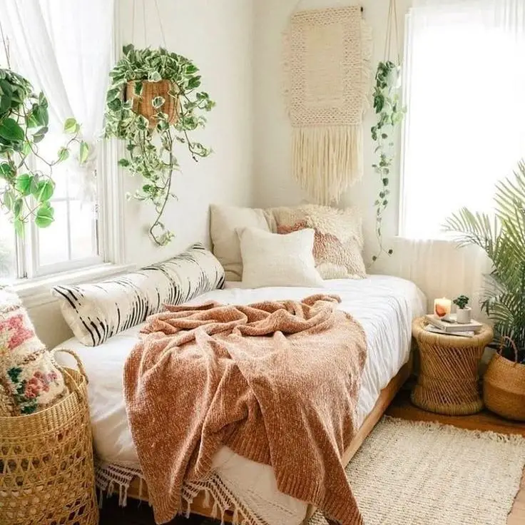  White bedroom with hanging plants macrame and terracotta accents