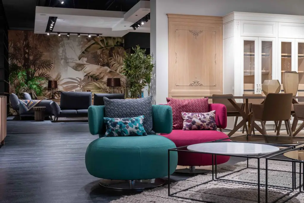Showroom with colorful modular seating and tropical mural.
